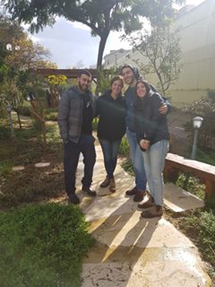 Image may contain: 4 people, people smiling, people standing, tree, shoes, plant, outdoor and nature